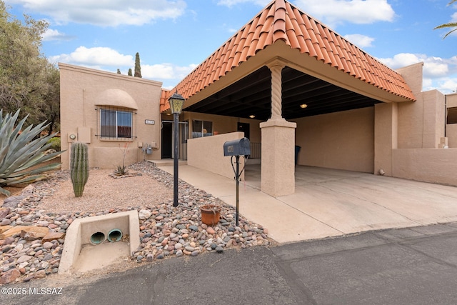 exterior space featuring an attached carport and driveway