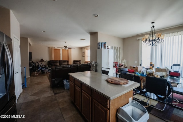 kitchen featuring open floor plan, plenty of natural light, and freestanding refrigerator