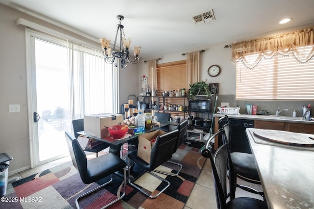dining room featuring a chandelier, visible vents, and light tile patterned floors