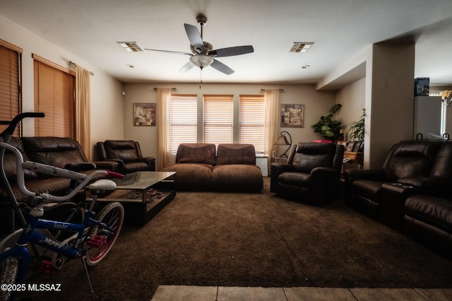 carpeted living area featuring visible vents and ceiling fan