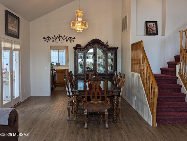 dining space with visible vents, french doors, stairs, and wood finished floors