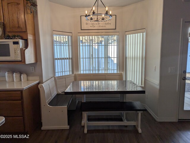 kitchen featuring stainless steel appliances, visible vents, dark wood-style floors, and light countertops