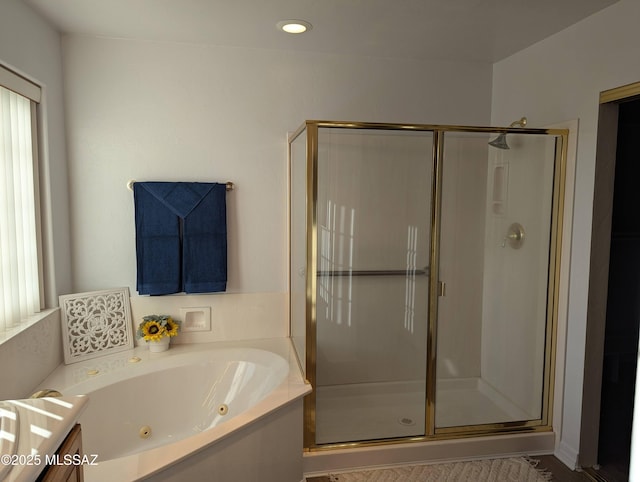 bathroom featuring a shower stall, recessed lighting, and a whirlpool tub