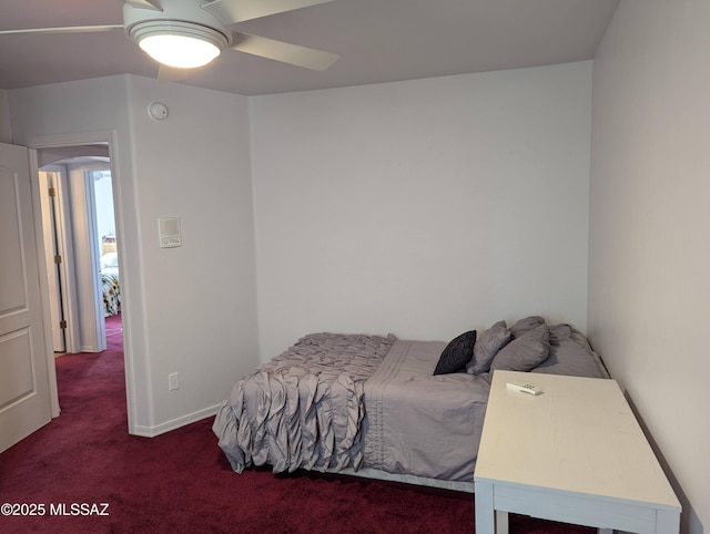 bedroom featuring baseboards, ceiling fan, and carpet flooring