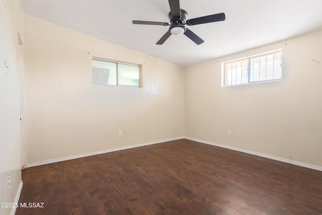 unfurnished room featuring wood finished floors, a ceiling fan, and baseboards