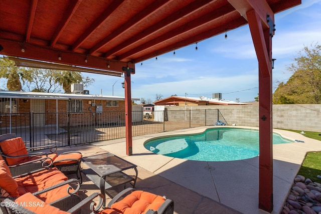 view of swimming pool with central air condition unit, a patio area, a fenced backyard, and a fenced in pool