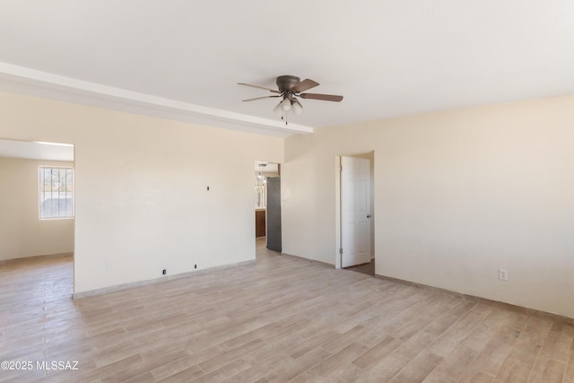 empty room with light wood finished floors and ceiling fan