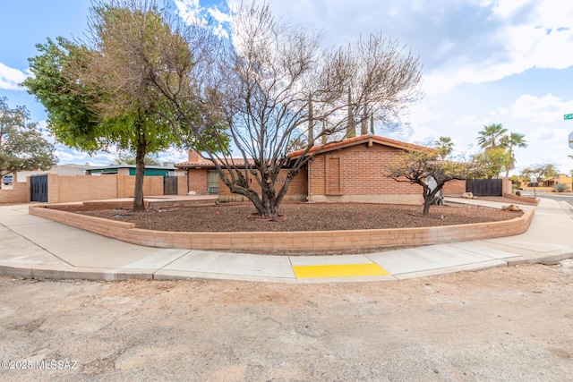 view of front of home with fence and brick siding