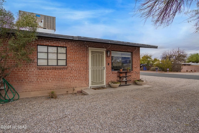 exterior space featuring brick siding