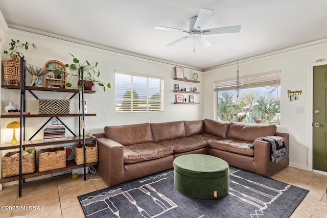 living area with tile patterned floors, plenty of natural light, a ceiling fan, and ornamental molding