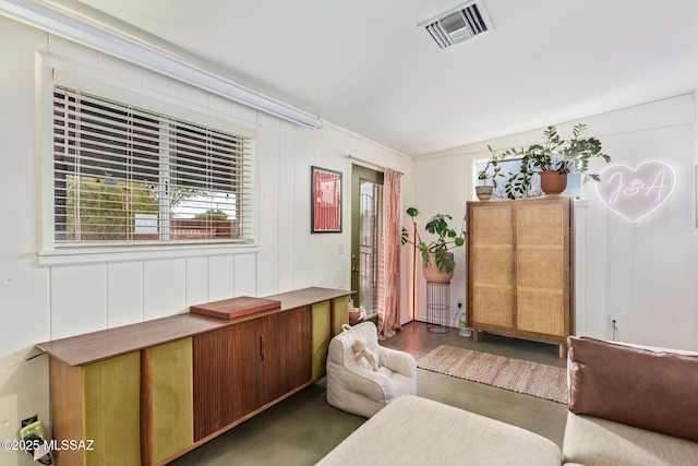 living area with visible vents and finished concrete floors