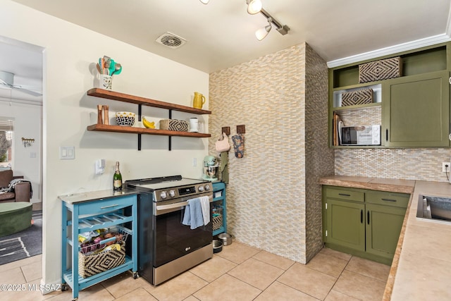 kitchen with green cabinets, open shelves, stainless steel electric stove, and light tile patterned floors