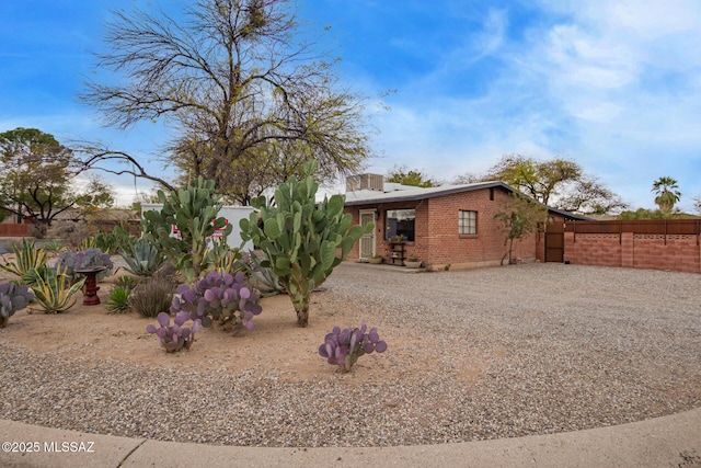 exterior space featuring driveway and fence