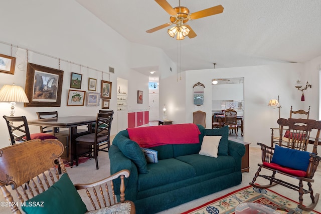 living area with a ceiling fan, carpet flooring, vaulted ceiling, and visible vents