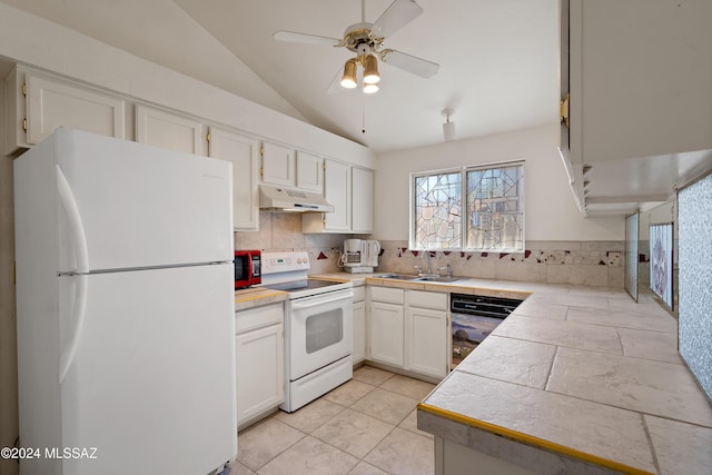 kitchen featuring white appliances, a sink, white cabinetry, and under cabinet range hood