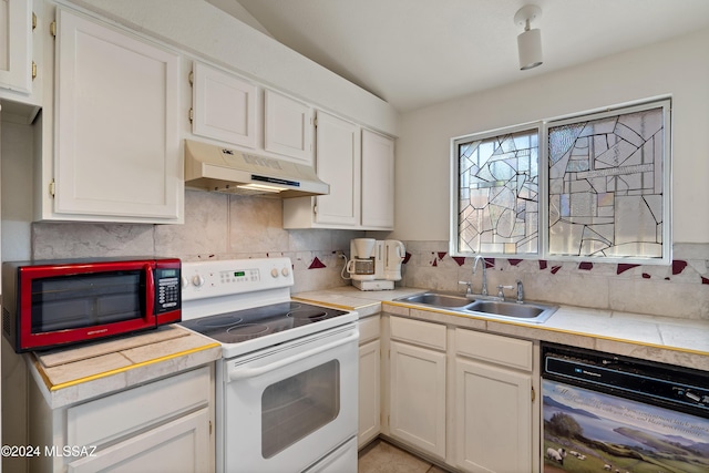 kitchen with electric range, dishwasher, light countertops, under cabinet range hood, and a sink