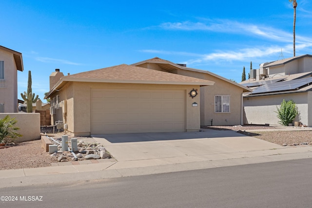 view of front of property with a garage, driveway, a chimney, roof with shingles, and stucco siding