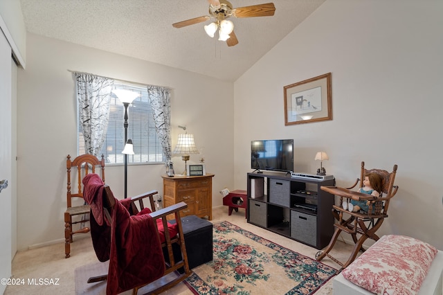 carpeted living area with lofted ceiling, baseboards, a ceiling fan, and a textured ceiling