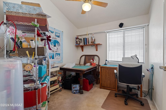 office featuring a ceiling fan, lofted ceiling, and carpet flooring