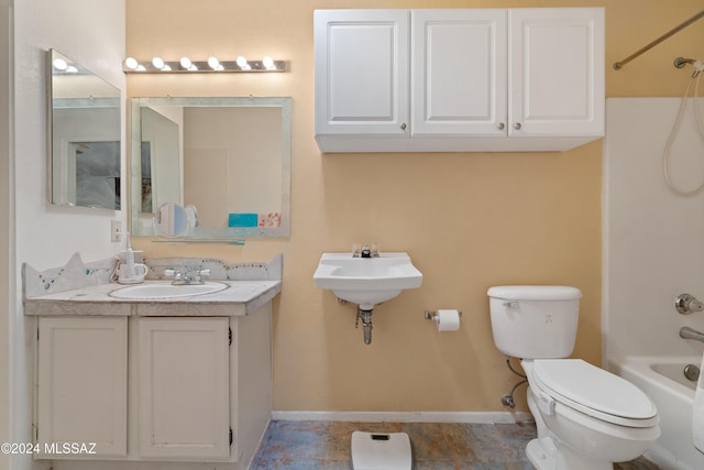 bathroom featuring toilet, a sink, washtub / shower combination, and baseboards