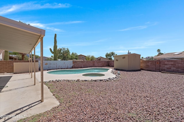 view of swimming pool featuring a fenced in pool, a patio area, a fenced backyard, and an outdoor structure