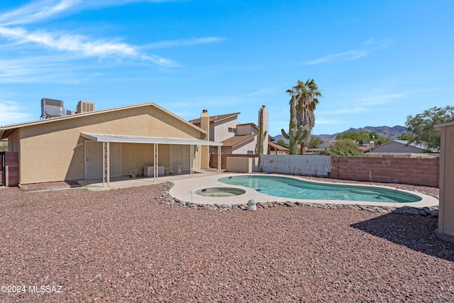 view of pool with a fenced in pool, a patio, a mountain view, an in ground hot tub, and a fenced backyard