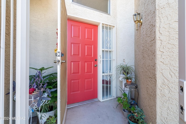 property entrance with stucco siding