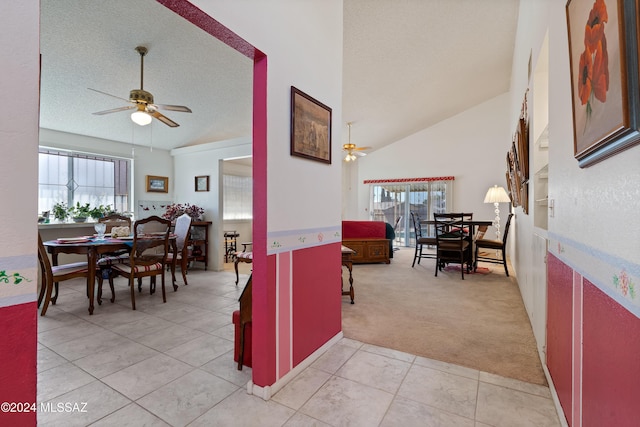 interior space featuring a textured ceiling, light tile patterned floors, plenty of natural light, and light colored carpet