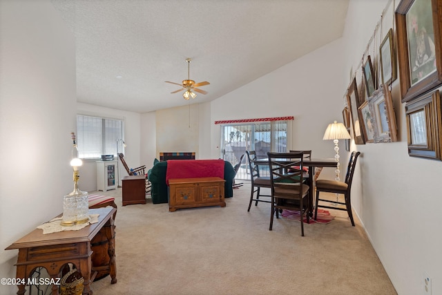 interior space featuring ceiling fan, vaulted ceiling, and a textured ceiling