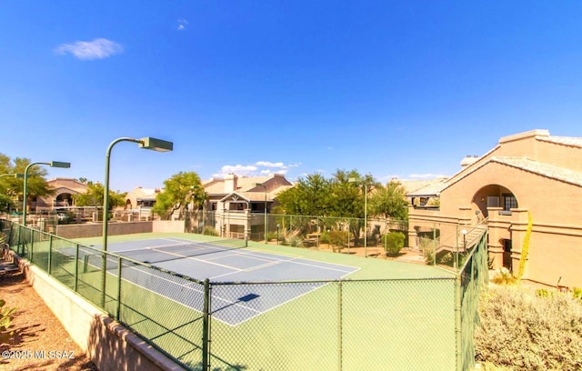 view of tennis court with fence