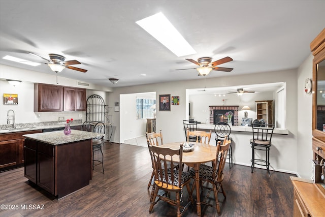 dining room featuring dark wood finished floors, visible vents, and a ceiling fan