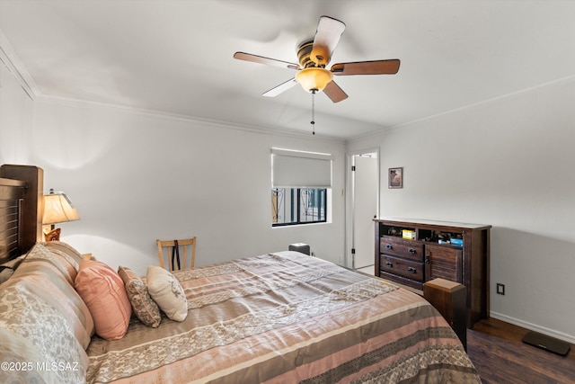 bedroom with a ceiling fan, wood finished floors, baseboards, and ornamental molding