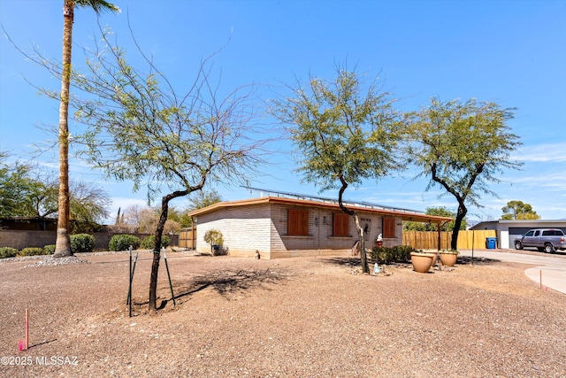 view of front of house featuring fence