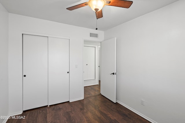 unfurnished bedroom with visible vents, wood finished floors, a closet, baseboards, and ceiling fan