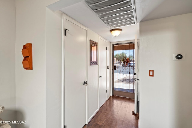 doorway to outside with visible vents and dark wood-style flooring