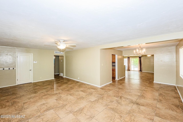 unfurnished room featuring baseboards, visible vents, and ceiling fan with notable chandelier