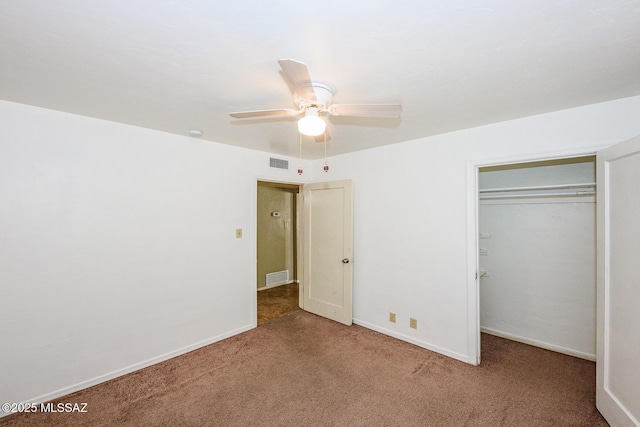 unfurnished bedroom with carpet floors, a closet, visible vents, and baseboards