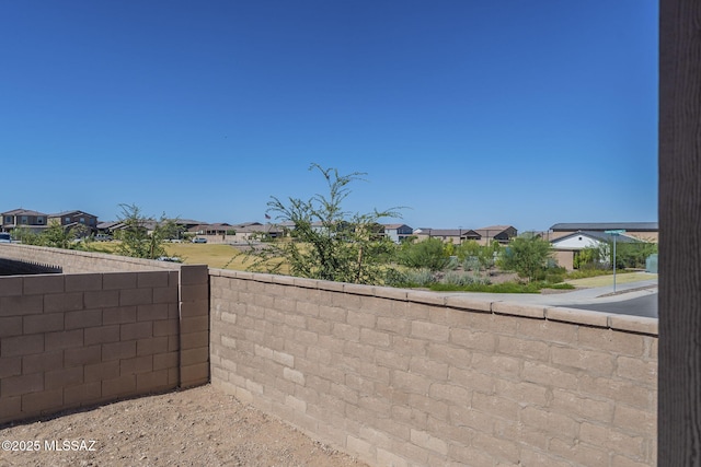 exterior space featuring a residential view and fence