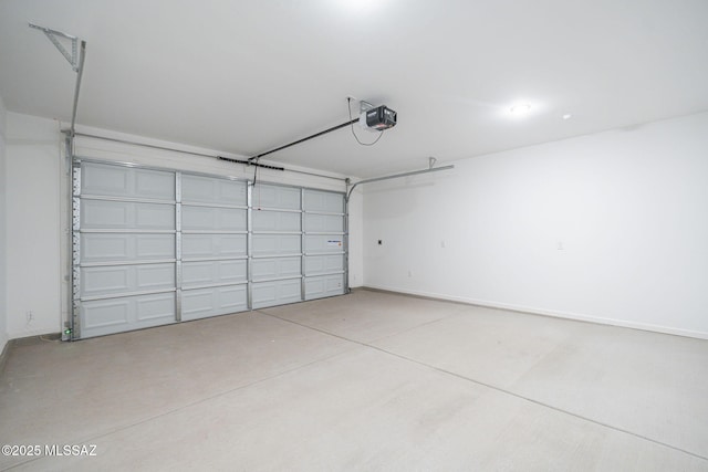 garage with baseboards and a garage door opener