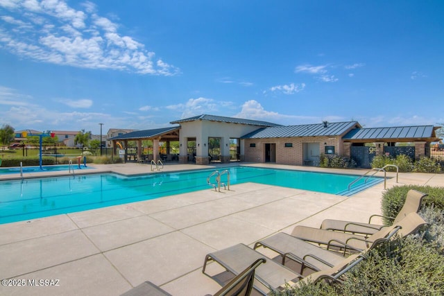 community pool with fence and a patio