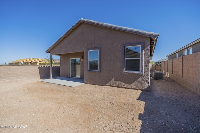 6826 E Paseo Berceo, Tucson, AZ 85756 - back of house featuring stucco siding, a fenced backyard, a patio, and central AC unit