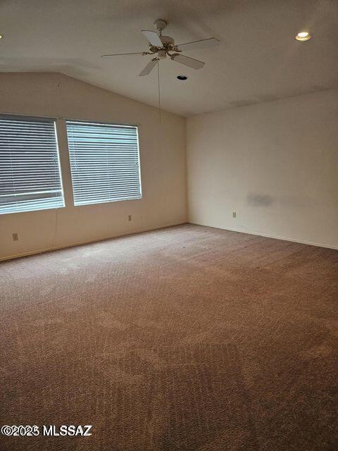 unfurnished room featuring lofted ceiling, ceiling fan, recessed lighting, and light colored carpet