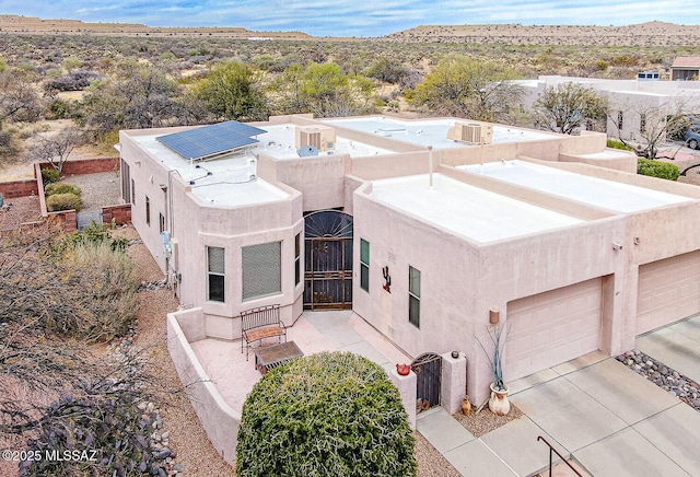 view of front of house featuring concrete driveway and stucco siding