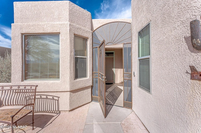 exterior space featuring a patio area and stucco siding