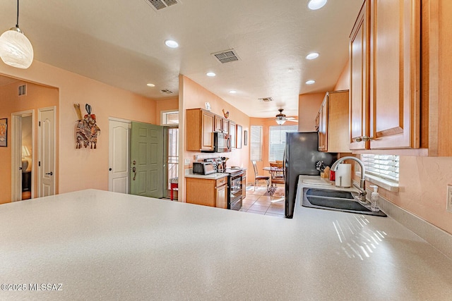 kitchen featuring brown cabinetry, a ceiling fan, black appliances, a sink, and recessed lighting