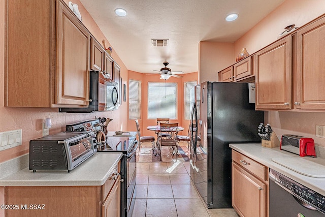 kitchen with light tile patterned floors, visible vents, ceiling fan, light countertops, and black appliances