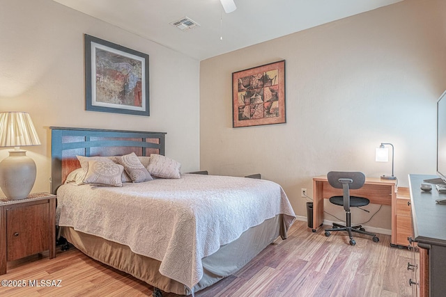 bedroom featuring visible vents, ceiling fan, light wood-style flooring, and baseboards