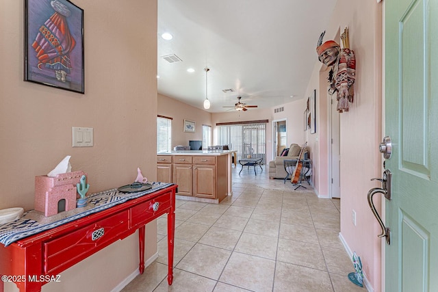 kitchen with visible vents, a ceiling fan, open floor plan, light tile patterned flooring, and baseboards