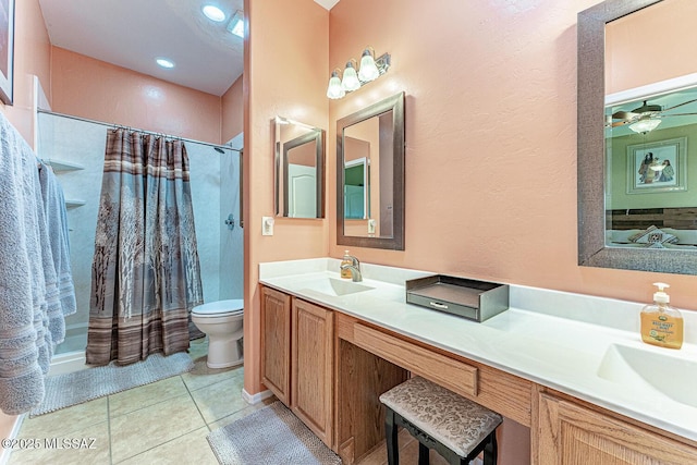 full bathroom with double vanity, toilet, curtained shower, tile patterned flooring, and a sink