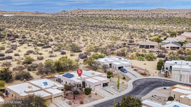 bird's eye view with view of desert, a residential view, and a mountain view